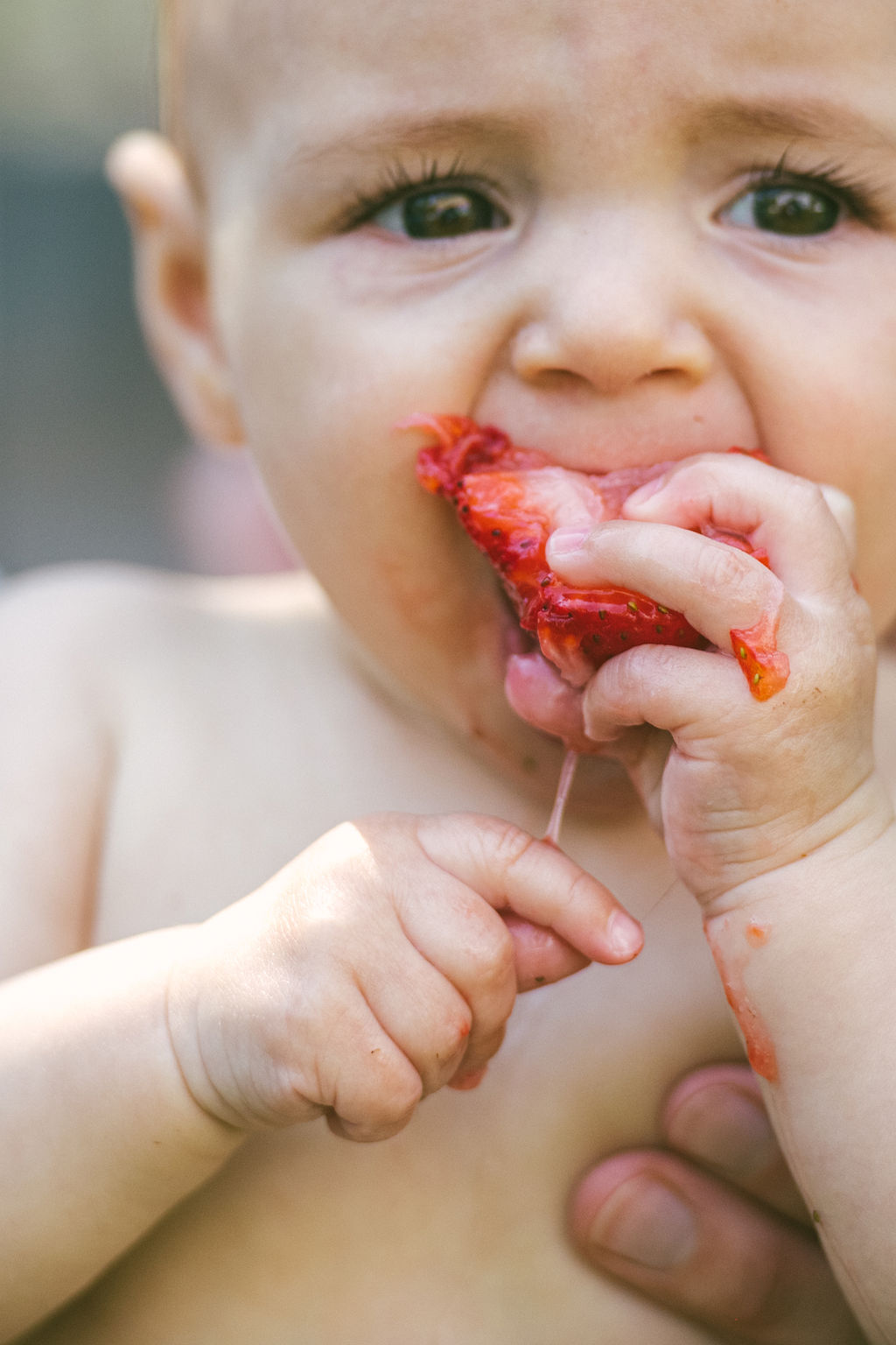 Child eating a strawberry